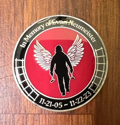 The Evan Neumeister Memorial Foundation Inc awards challenge coins to new firefighter recruits receiving Evans Memorial Scholarship covering tuition for Fire Academy